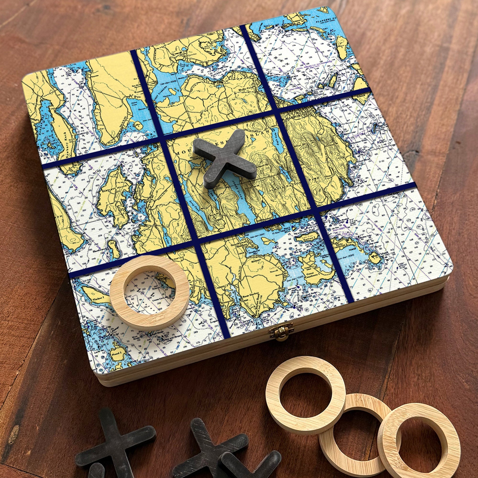 Wooden mancala game board with nautical chart print