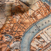 Vintage map of a city layout with streets and waterways, featuring French text.