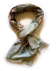 Scarf with nature-themed design on a white background