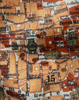 Textured fabric with printed map design featuring various labels and text.