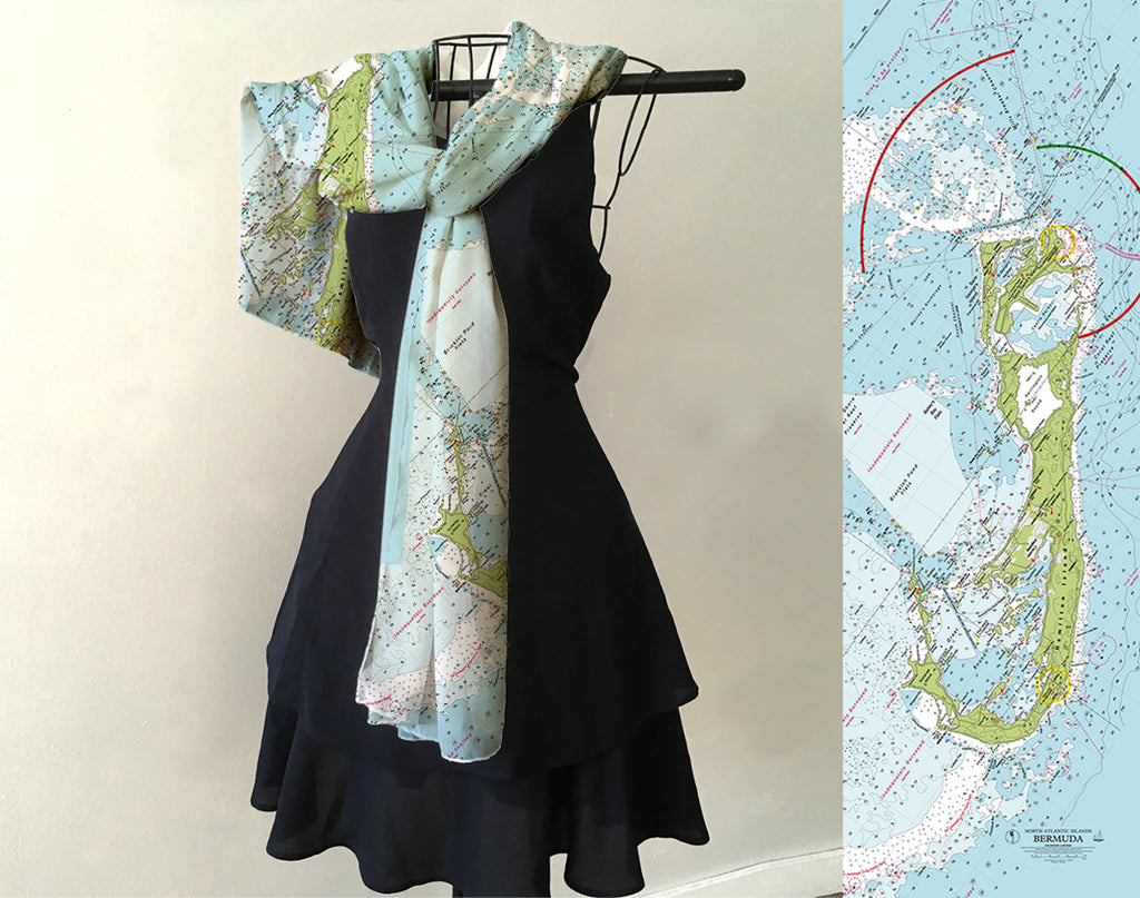 Black dress with a map-patterned scarf draped over a hanger, next to a map of Cape Cod.
