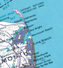 A close-up of a vintage-style map showing the coastal area of Gloucester, Massachusetts, with labeled places such as Gateway National Recreation Area, Atlantic Highlands, Rumson, Sea Bright, Monmouth Beach, Long Branch, and Allenhurst. The map uses blue water, white land, and purple shaded regions.
