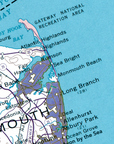 A close-up of a vintage-style map showing the coastal area of Gloucester, Massachusetts, with labeled places such as Gateway National Recreation Area, Atlantic Highlands, Rumson, Sea Bright, Monmouth Beach, Long Branch, and Allenhurst. The map uses blue water, white land, and purple shaded regions.